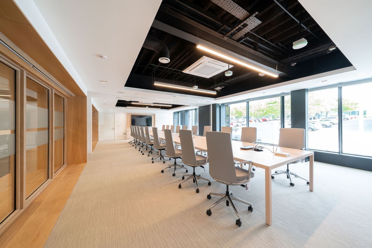 A large conference room with a long table and chairs.