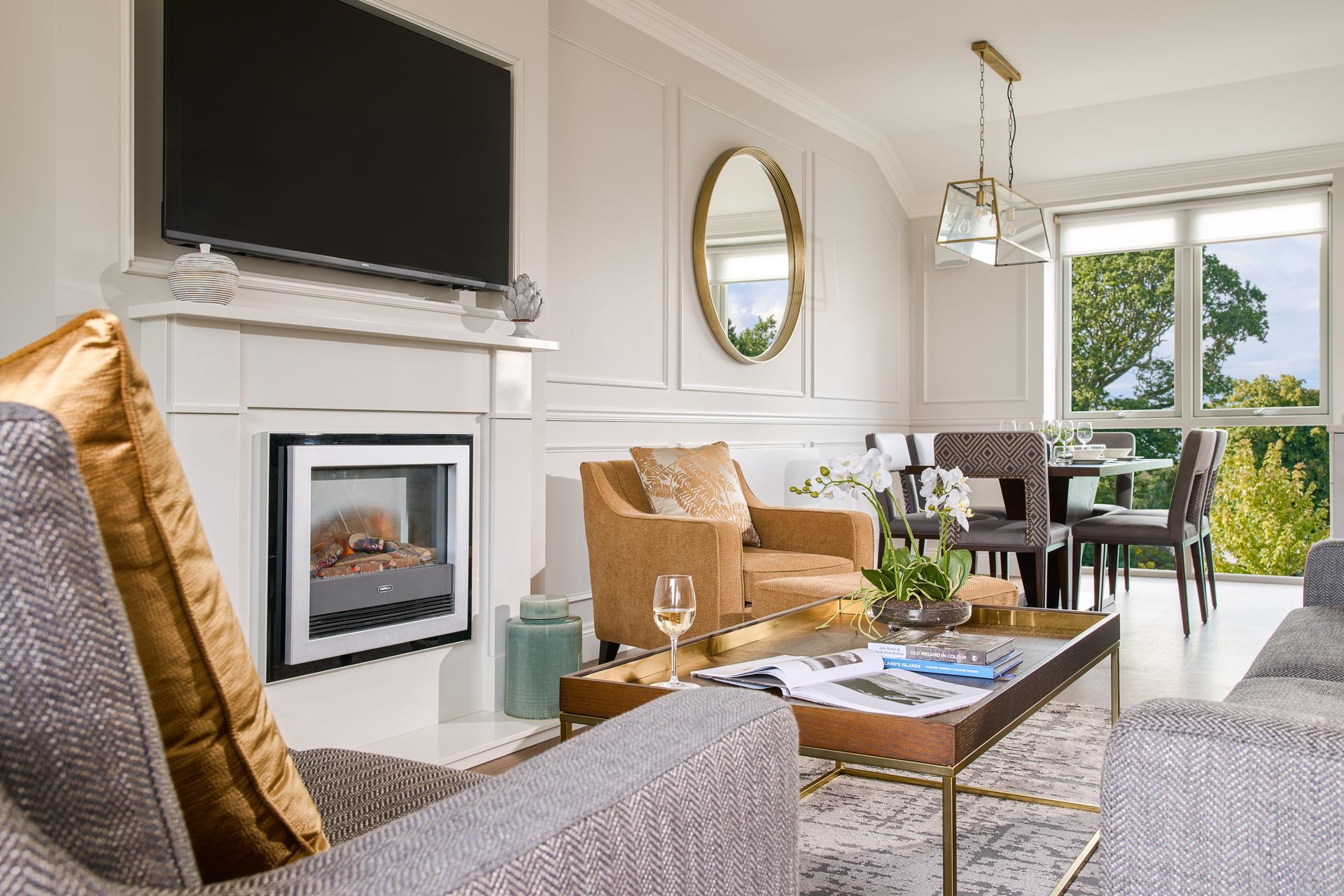 A living room with a fireplace and a flat screen tv.