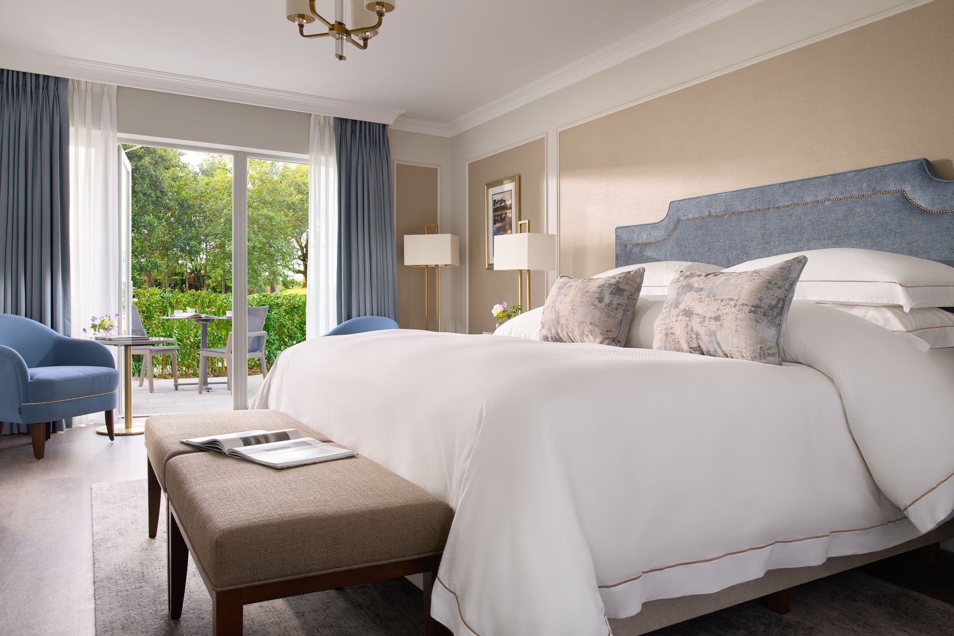 An artist 's impression of a hotel room with a large bed and a bench.