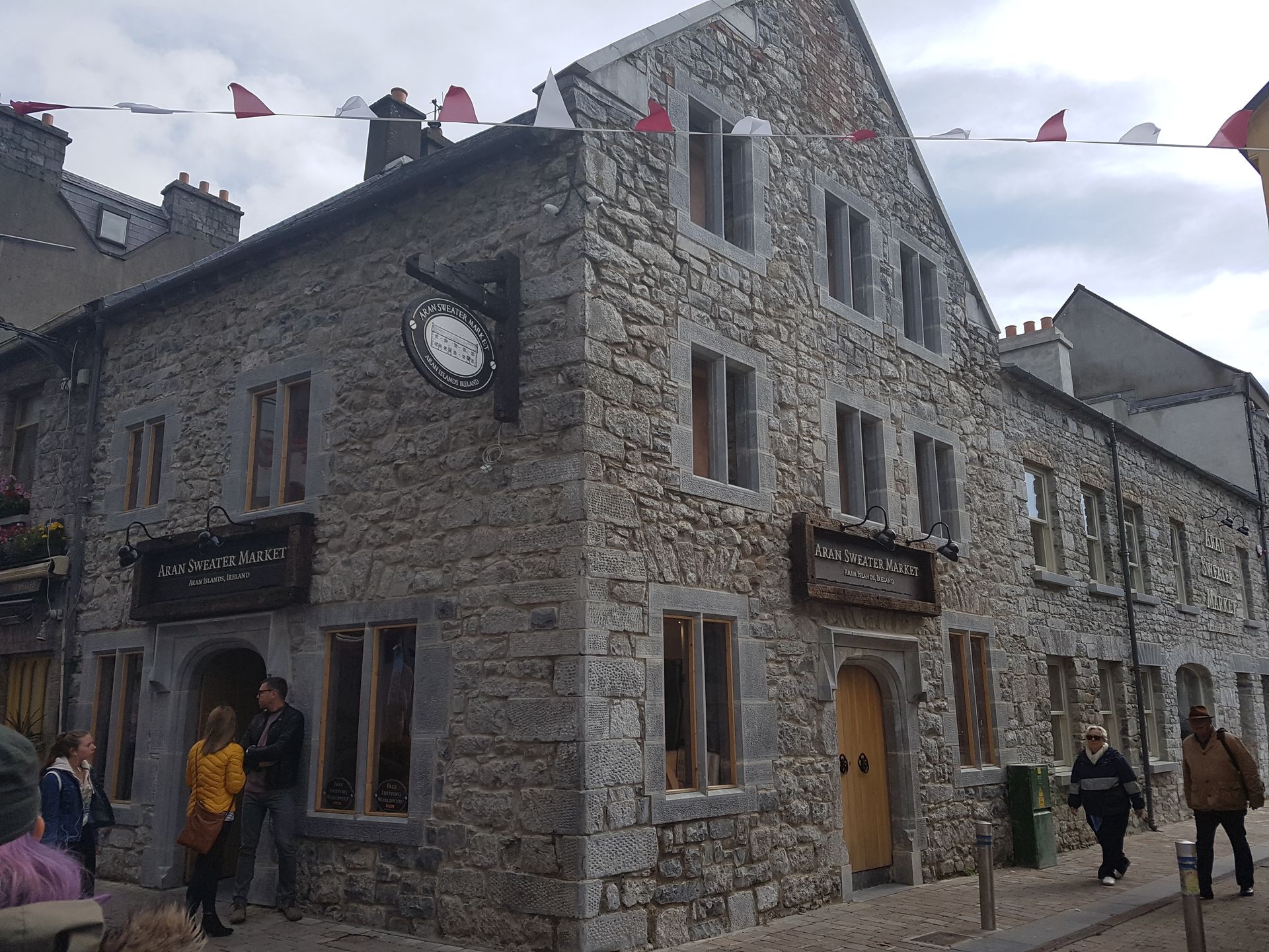A stone building with a clock on the side of it