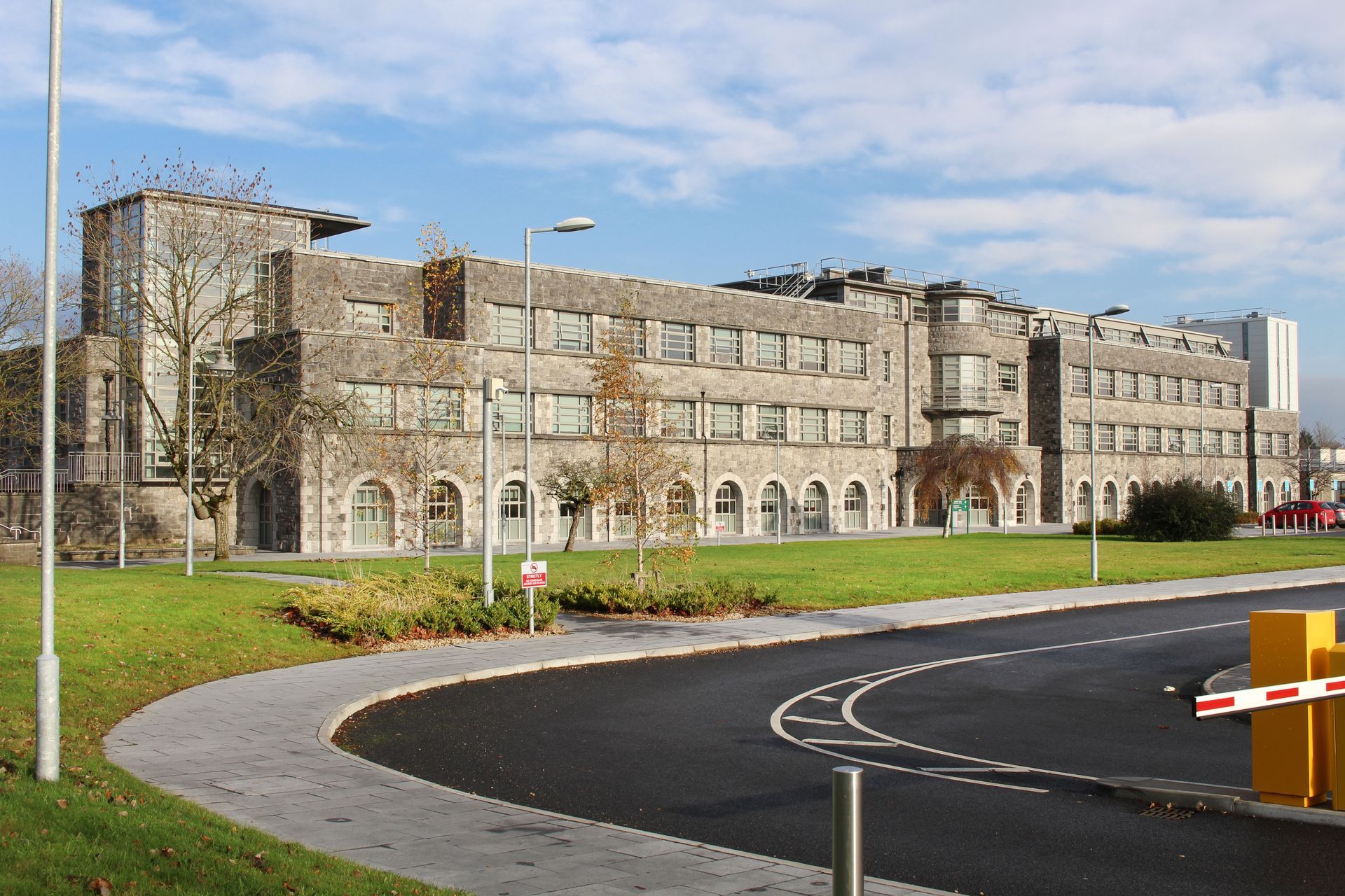 A large building with a parking barrier in front of it