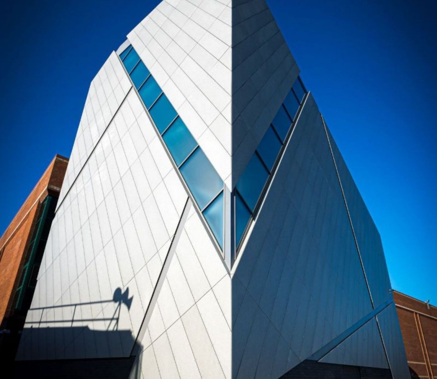 A white building with a blue sky in the background