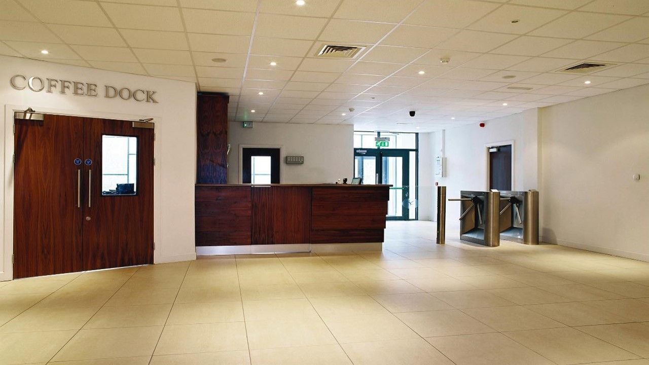 An empty lobby with a coffee dock sign on the wall