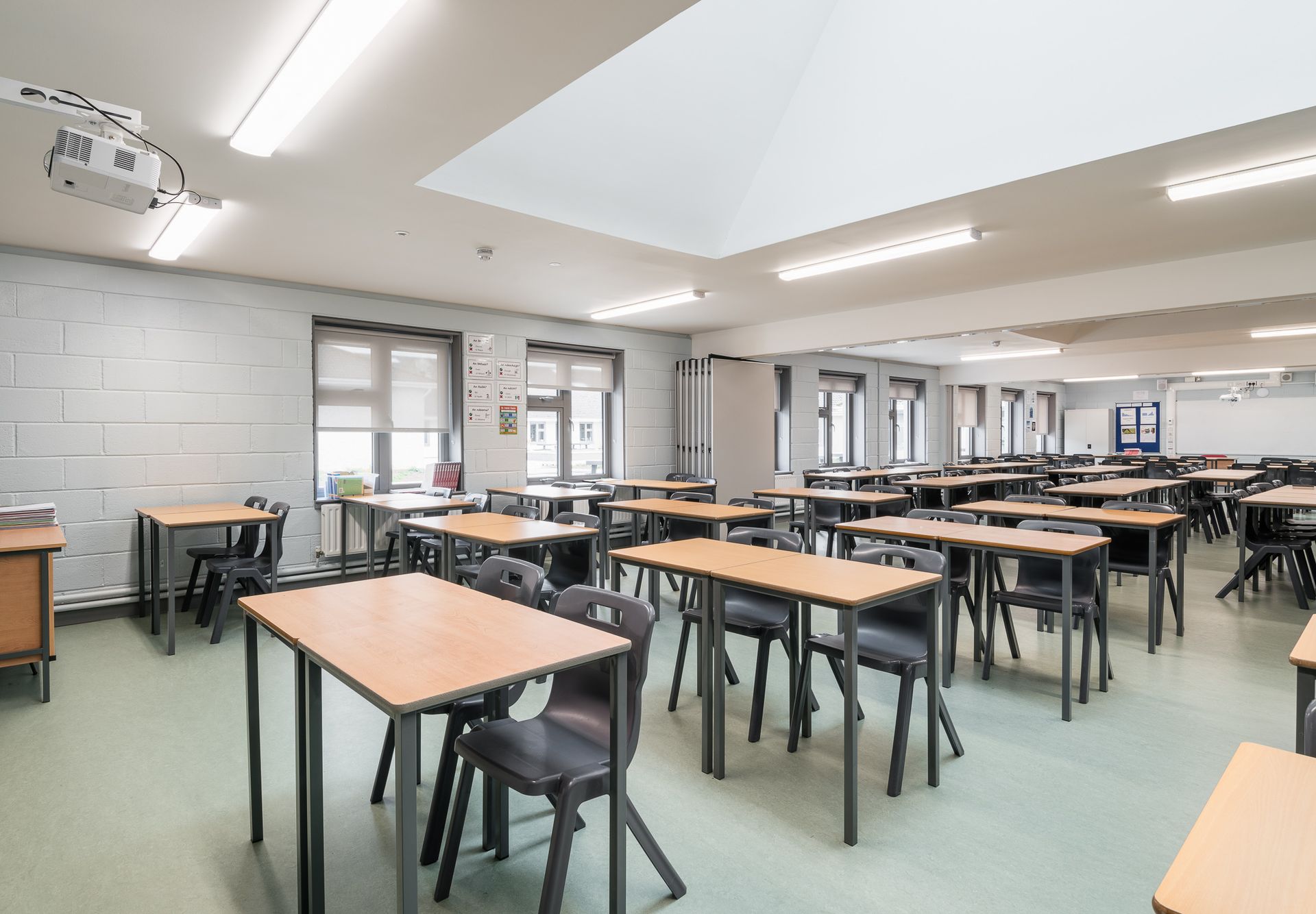 A large classroom with lots of tables and chairs