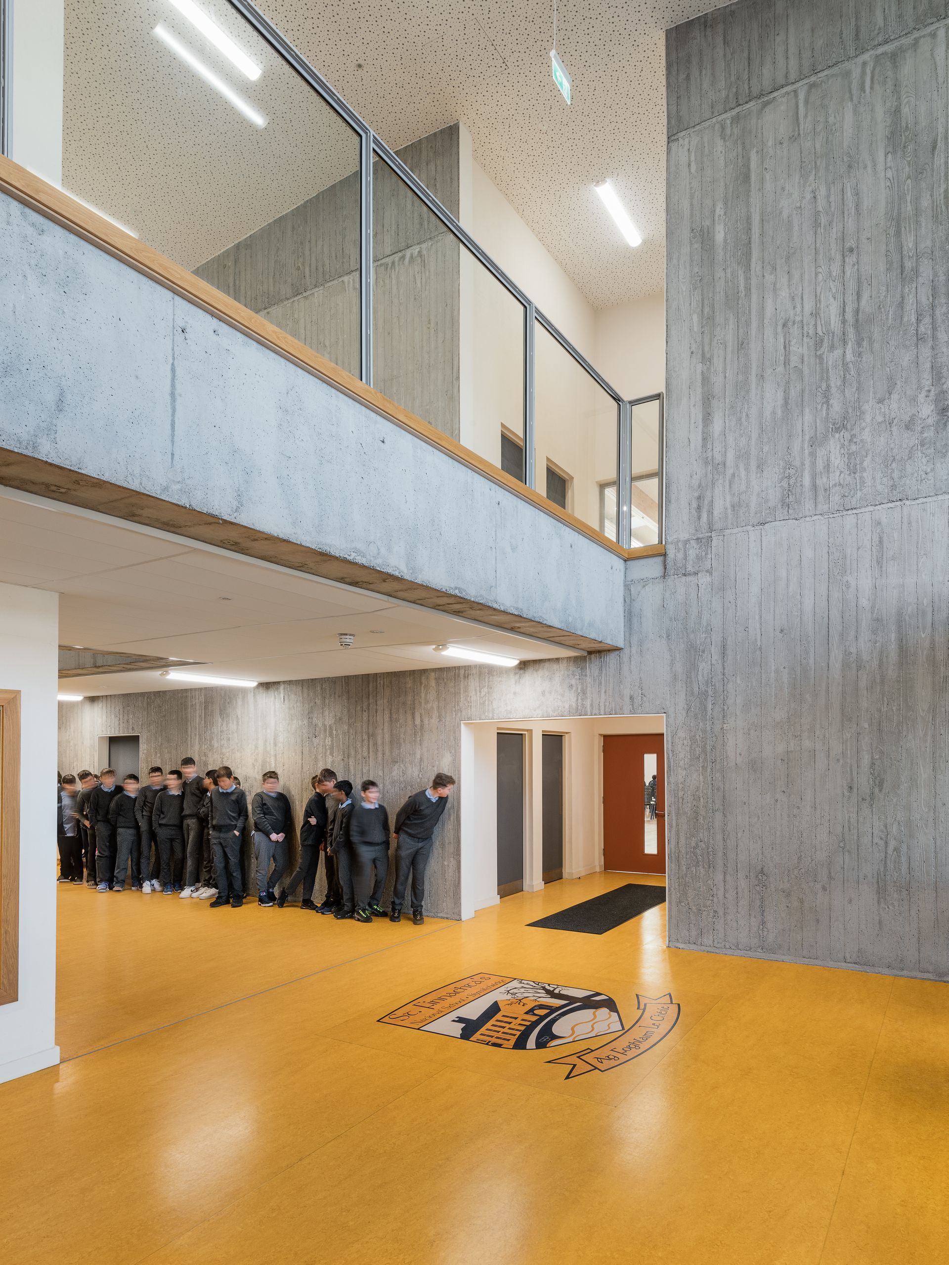 A group of people are standing in a hallway in a building