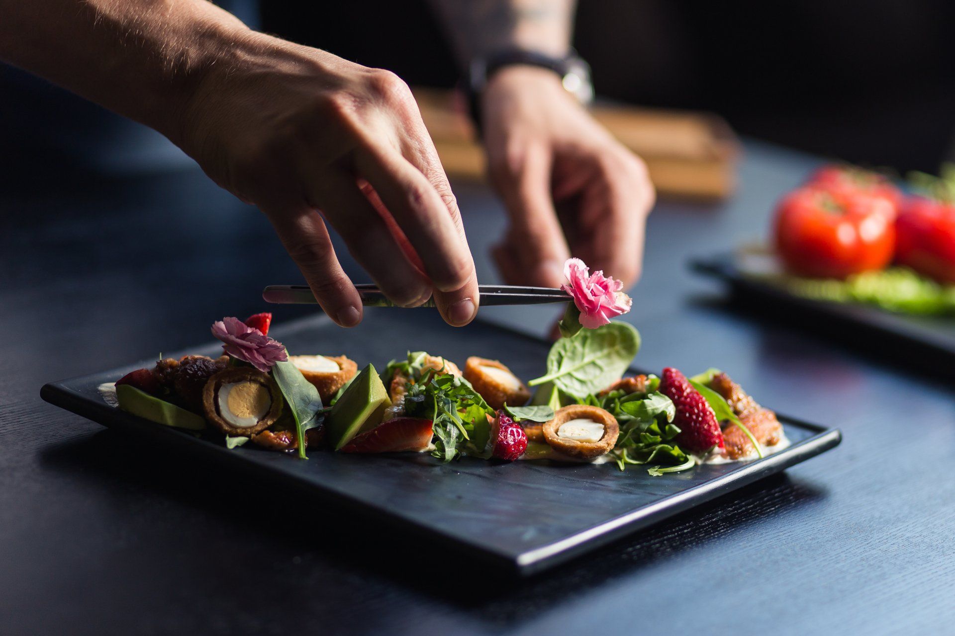 A person is decorating a plate of food with a flower.