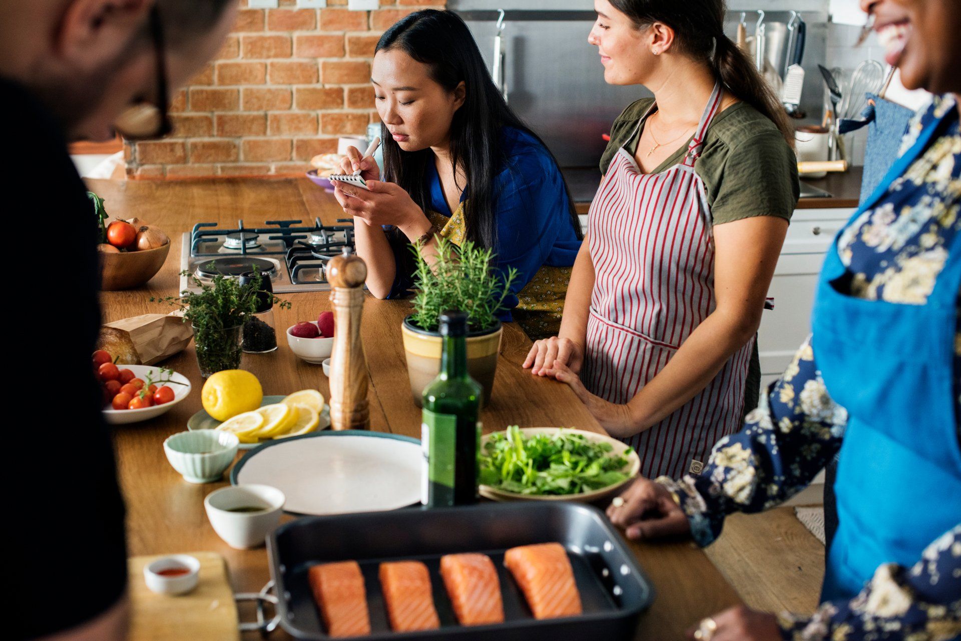 A group of people are cooking together in a kitchen.