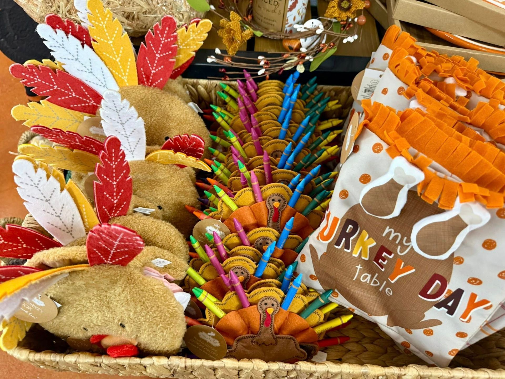 Several colorful glass rooster garden stakes displayed on metal poles inside a store.