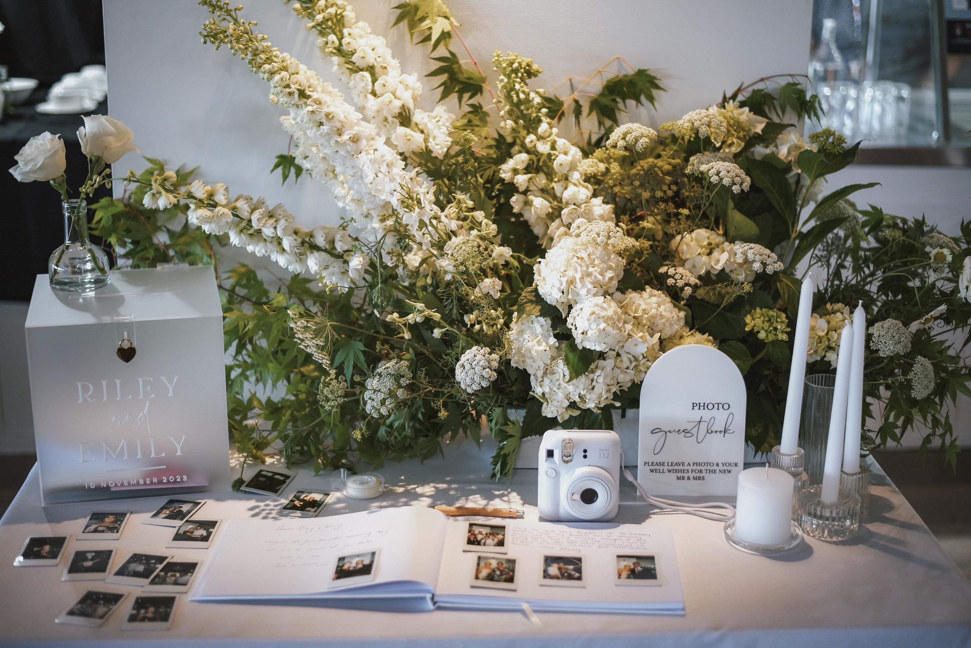 A Table With Flowers, Candles, a Book and a Camera on it - Function Venue in Hillvue, NSW