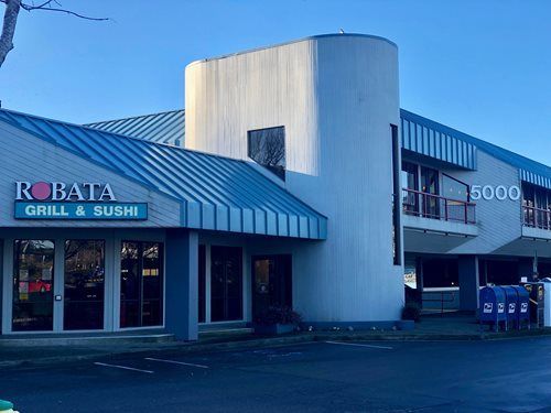 Robata Grill & Sushi restaurant entrance and exterior on a sunny day with mailboxes in front.