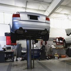 Cars on hydraulic lifts at auto repair shop