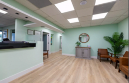 A waiting room with chairs and a mirror on the wall