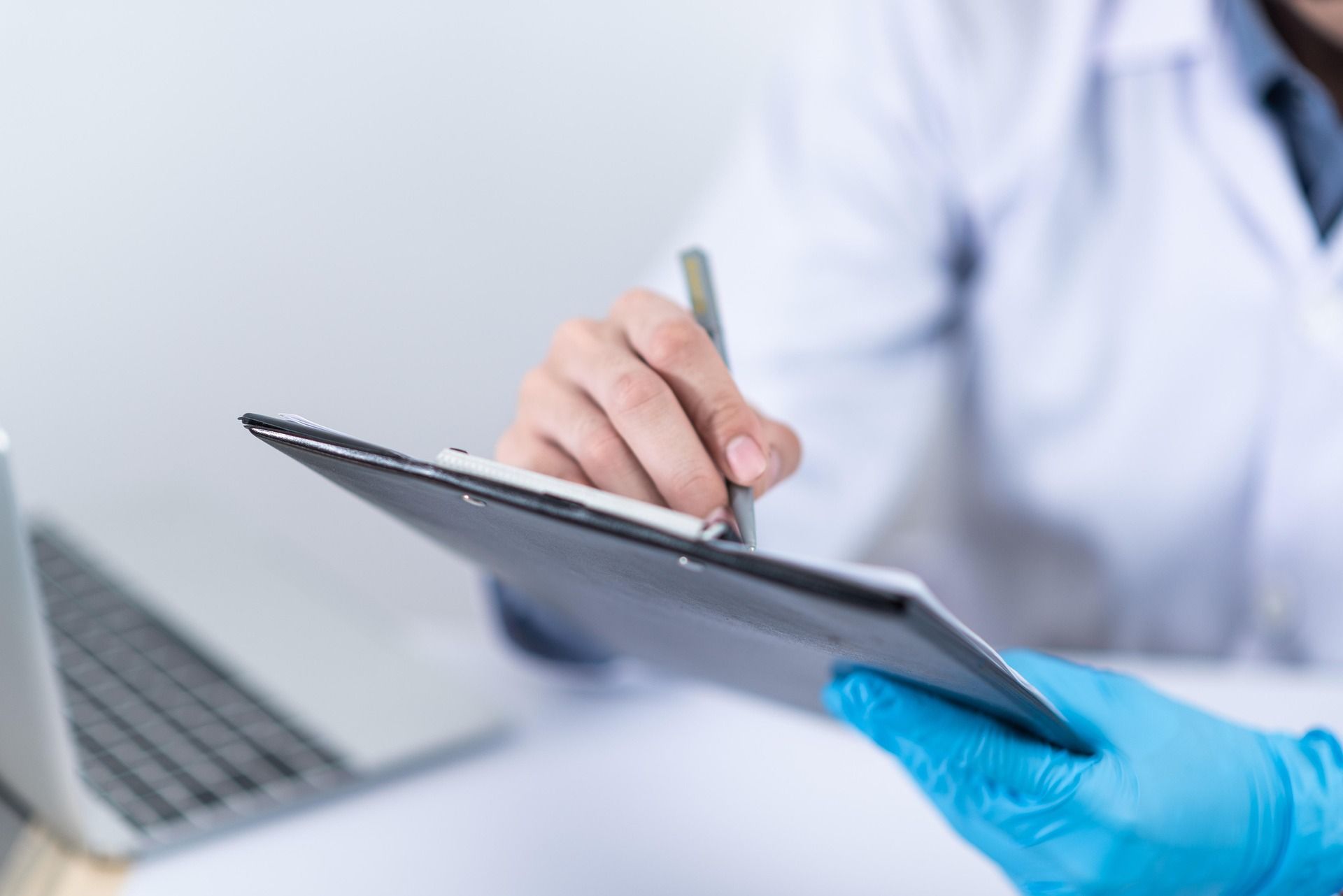 doctor holding paperwork on clipboard