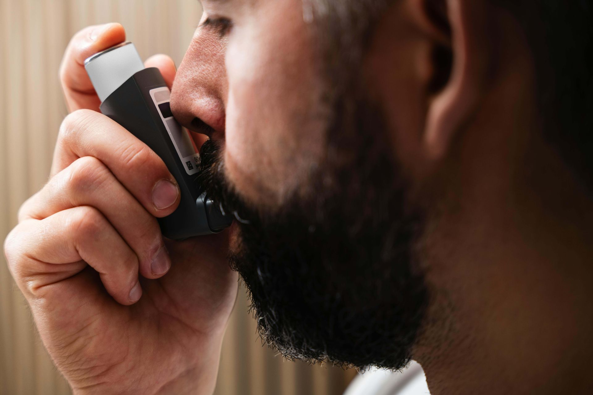 man using an inhaler