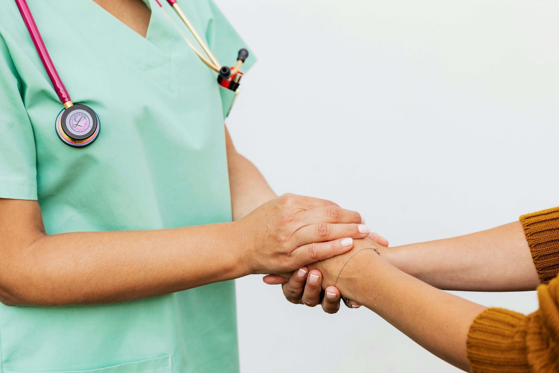nurse holding patient's hand