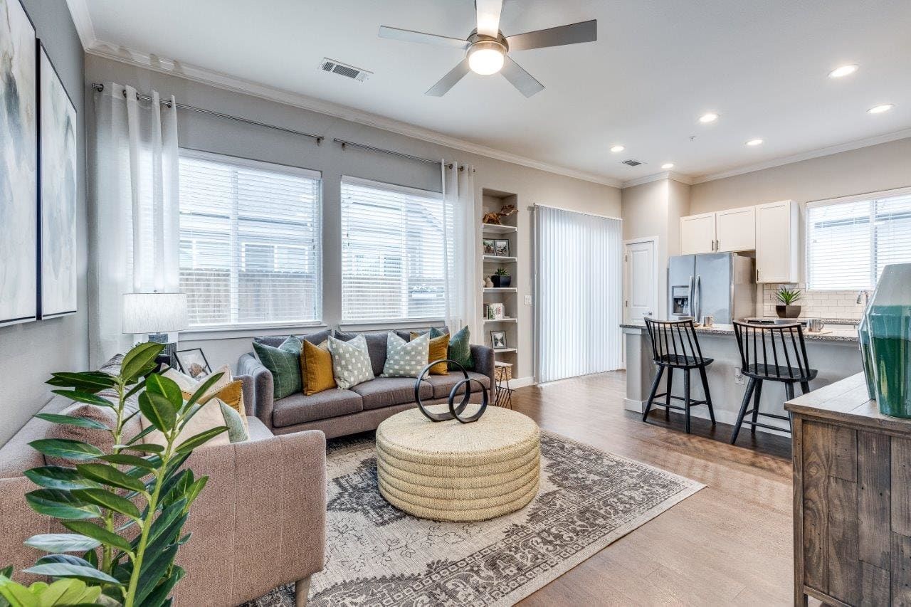 A living room filled with furniture and a ceiling fan.