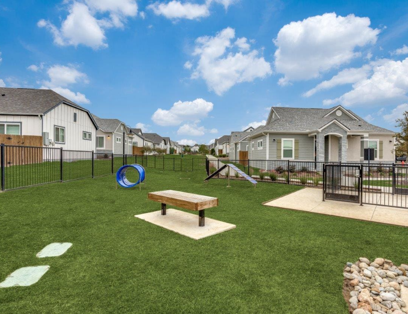 There is a dog park in the middle of a residential area.