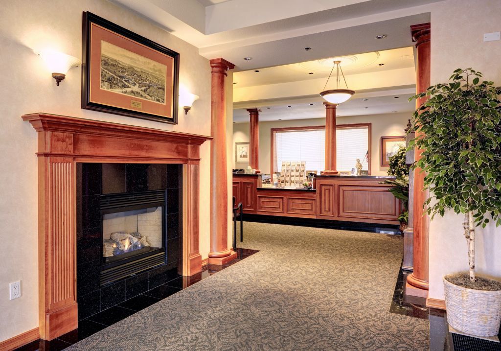 funeral home lobby with a fireplace and a picture on the wall