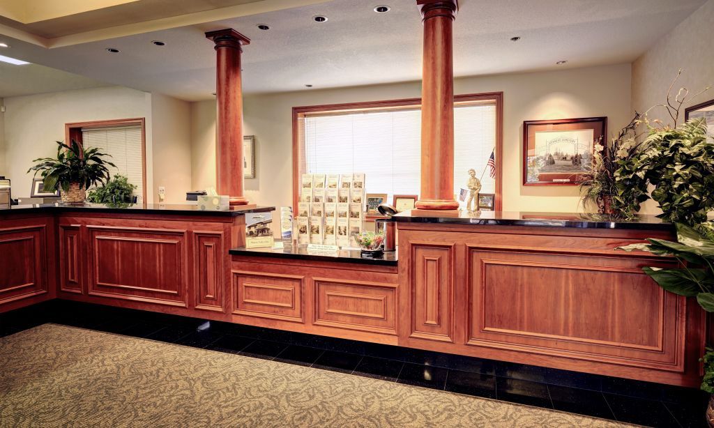 funeral home lobby with a wooden counter and columns