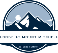 A logo for lodge at mount mitchell natural comfort