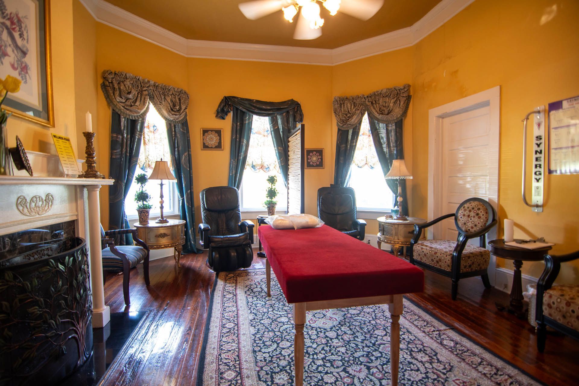A living room with a red table and chairs