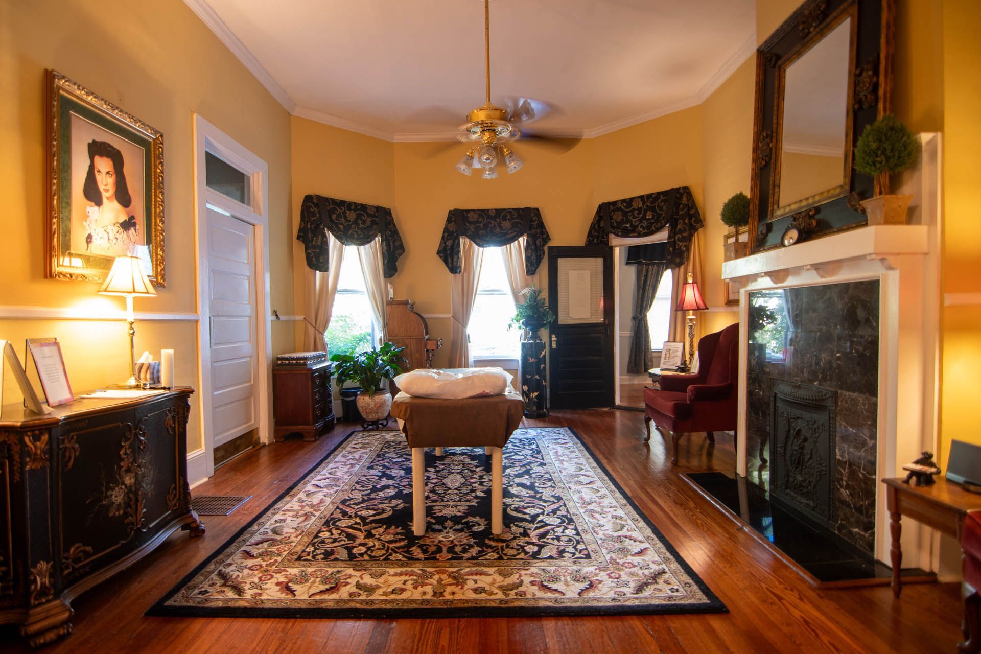 A living room with a fireplace and a ceiling fan