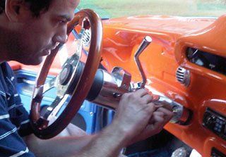 Auto locksmith working on a vintage car