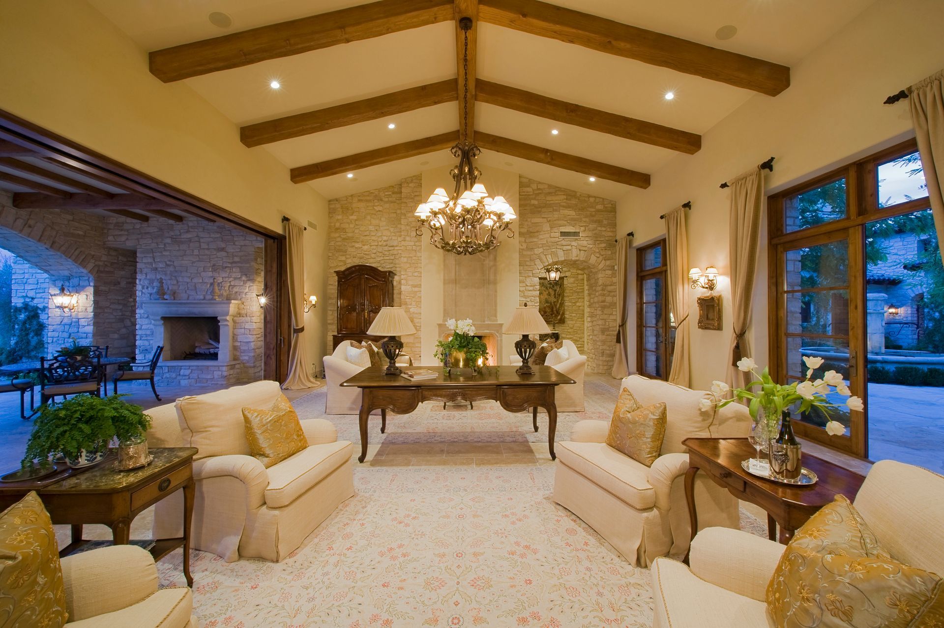 A living room with a vaulted ceiling and lots of furniture.