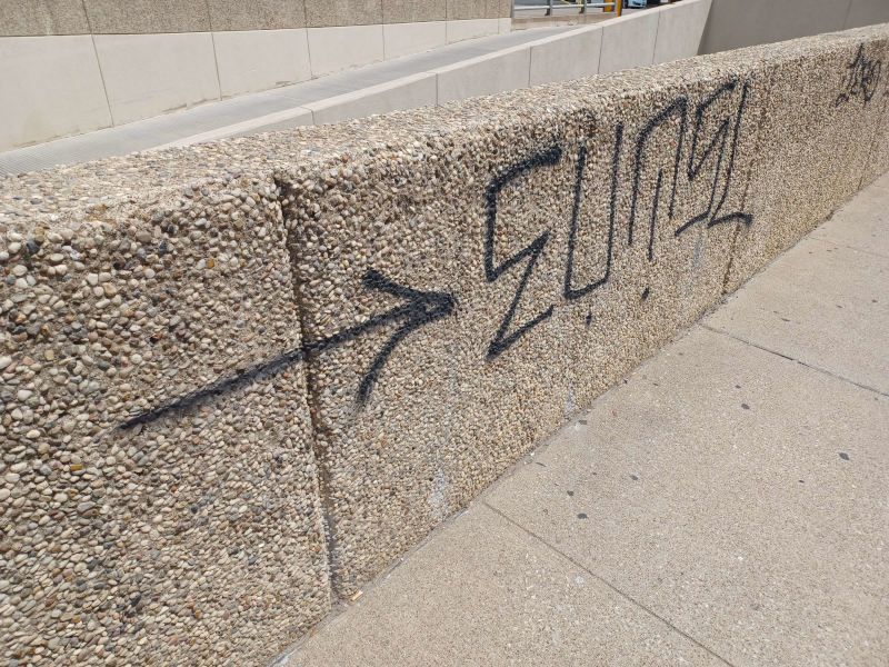 A concrete wall with graffiti on it including the word elina