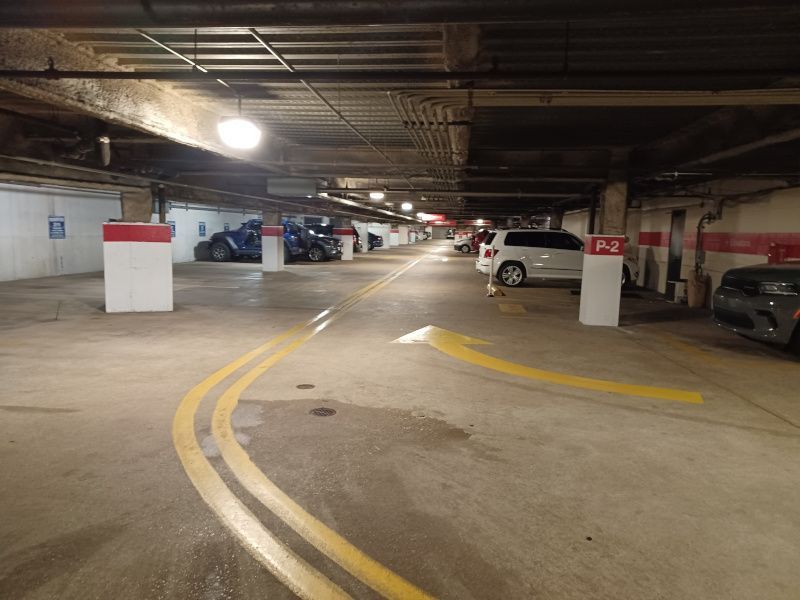 A parking garage with cars parked in the lower level