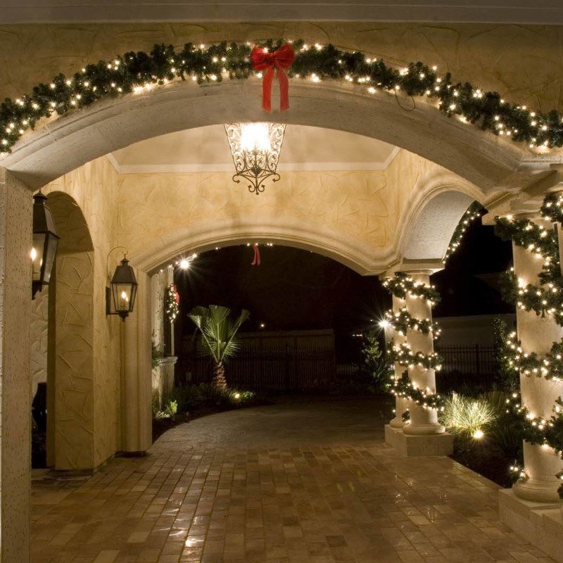 A hallway decorated with christmas lights and a red bow