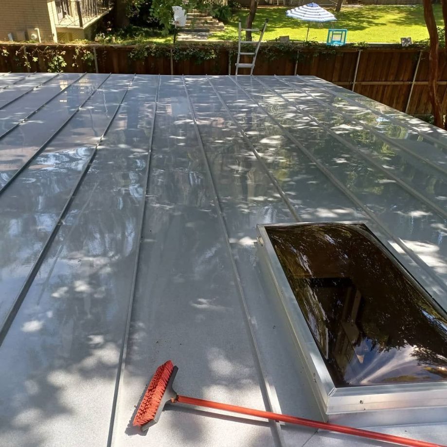 A roof is being soft washed.