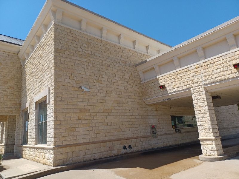 A large brick building with a blue sky in the background