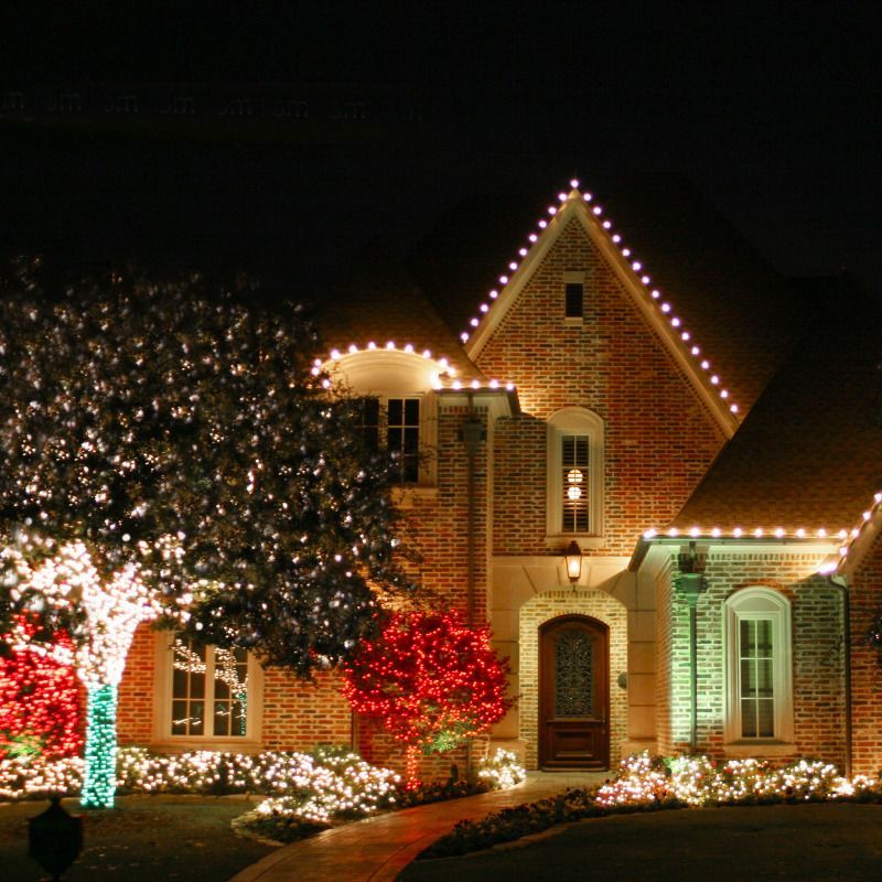 A house decorated with christmas lights at night