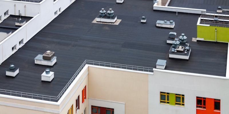 An aerial view of the roof of a building with a black roof.