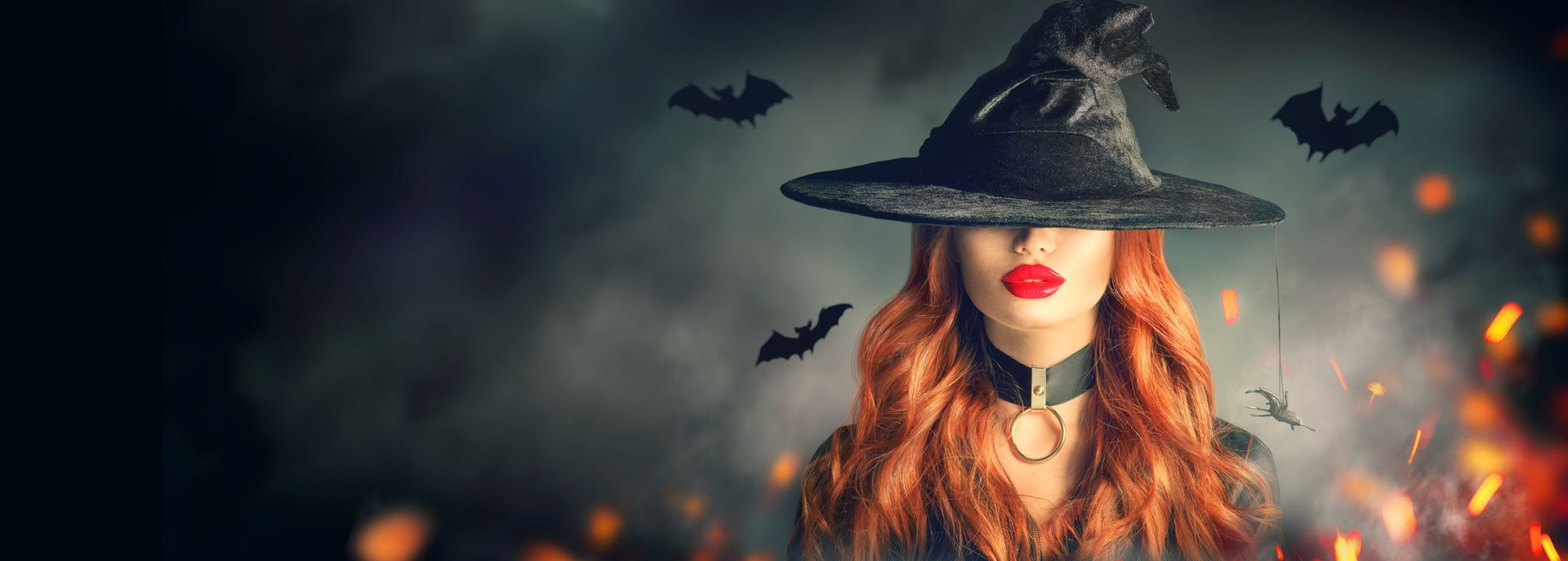 Beautiful Woman in a witch costume with sultry red lips and hidden eyebrows