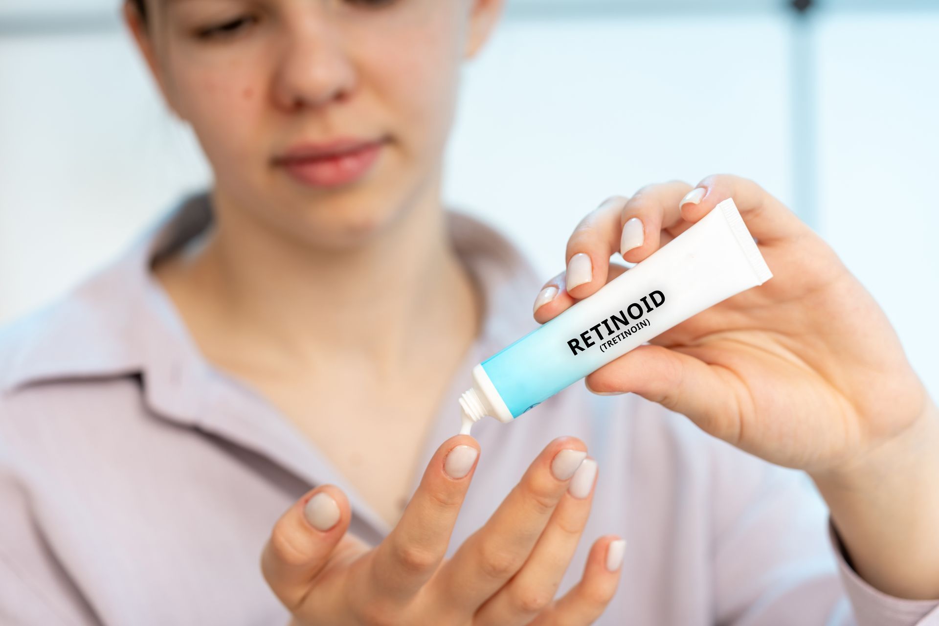 woman applying retinol cream