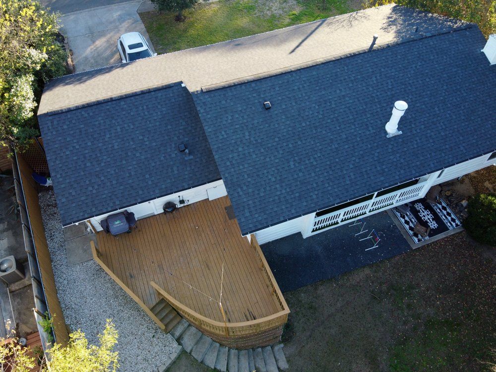 an aerial view of a house with a large deck