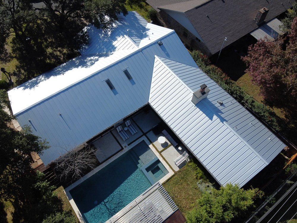 an aerial view of a house with a swimming pool