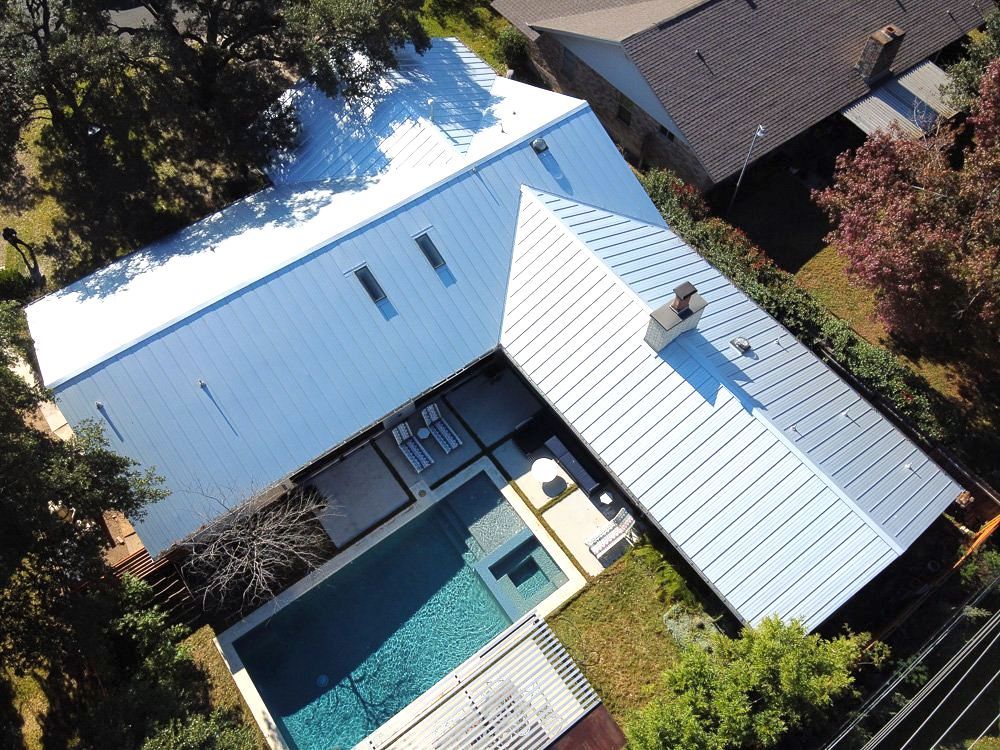 Brand new metal roof on a suburban home with a pool