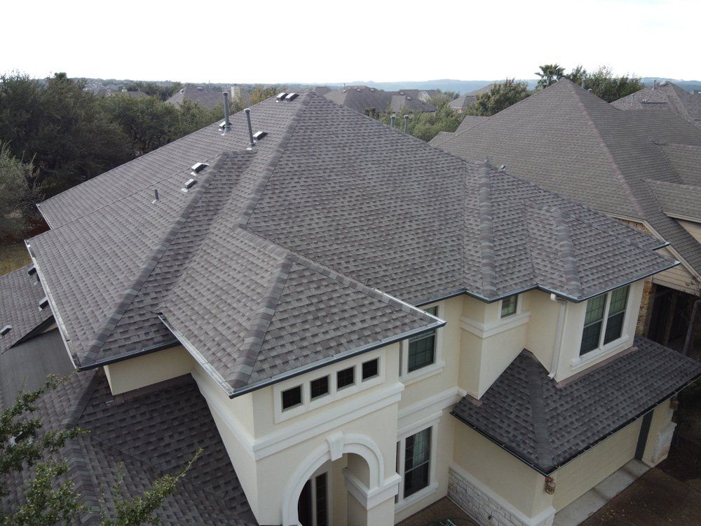 an aerial view of a large house with a gray roof .