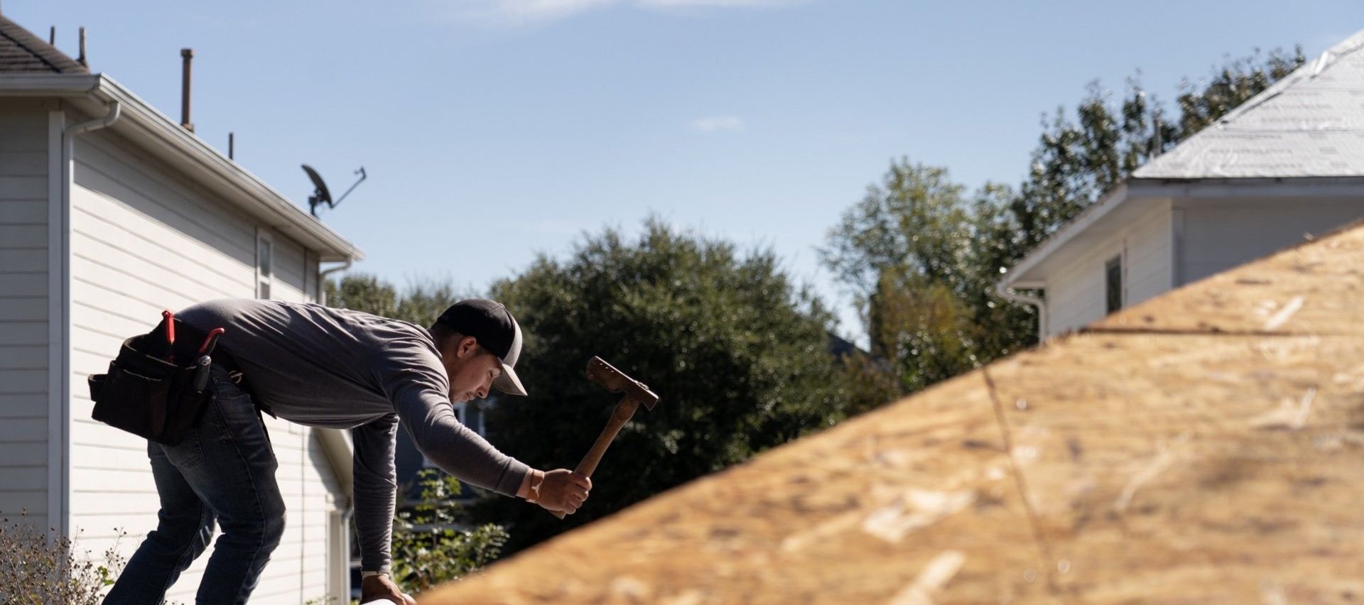 Professional roofer working on roof