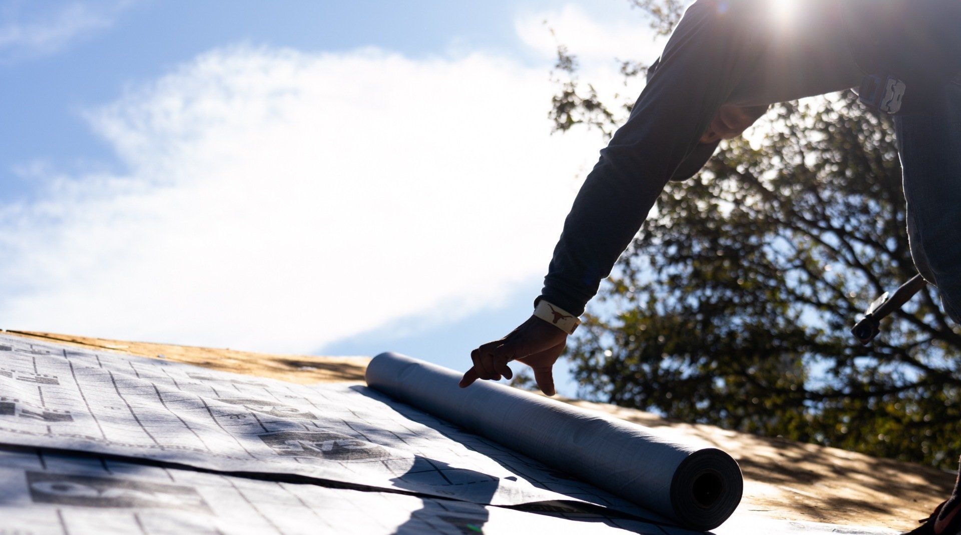 Roofer applying overlying to new roof