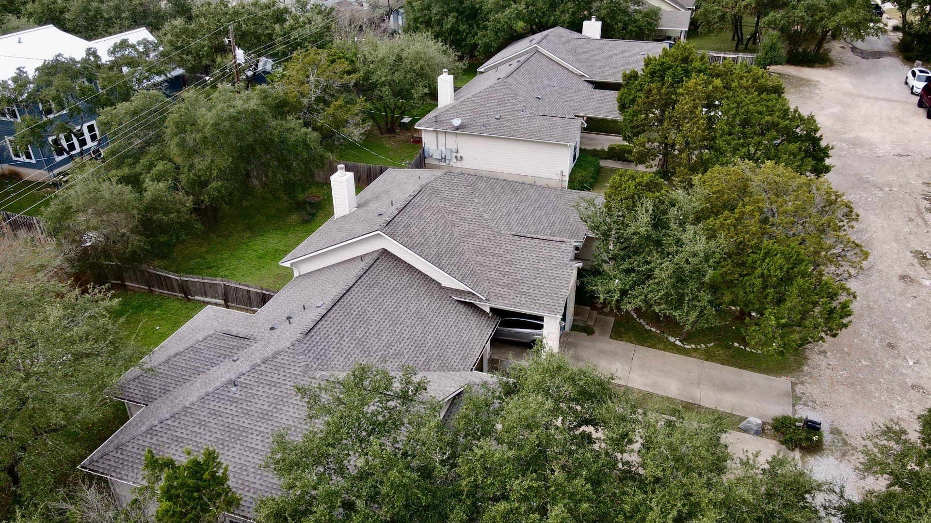 Overhead view of two Texas homes with brand new roofs from Birdcreek Roofing