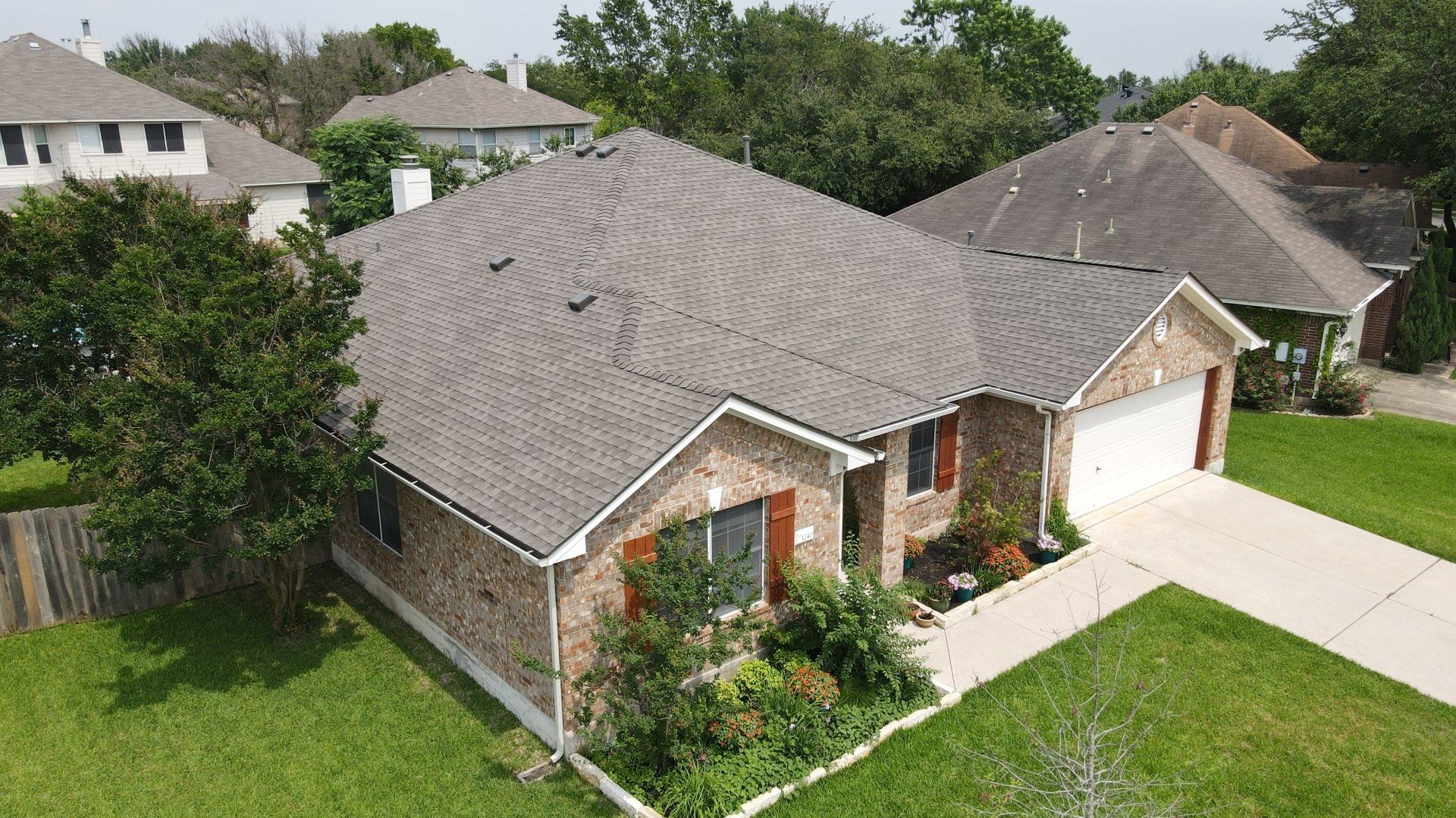 Aerial view of a brand new shingle roof in a suburban neighborhood