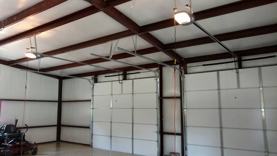 A garage with a motorcycle parked inside of it.