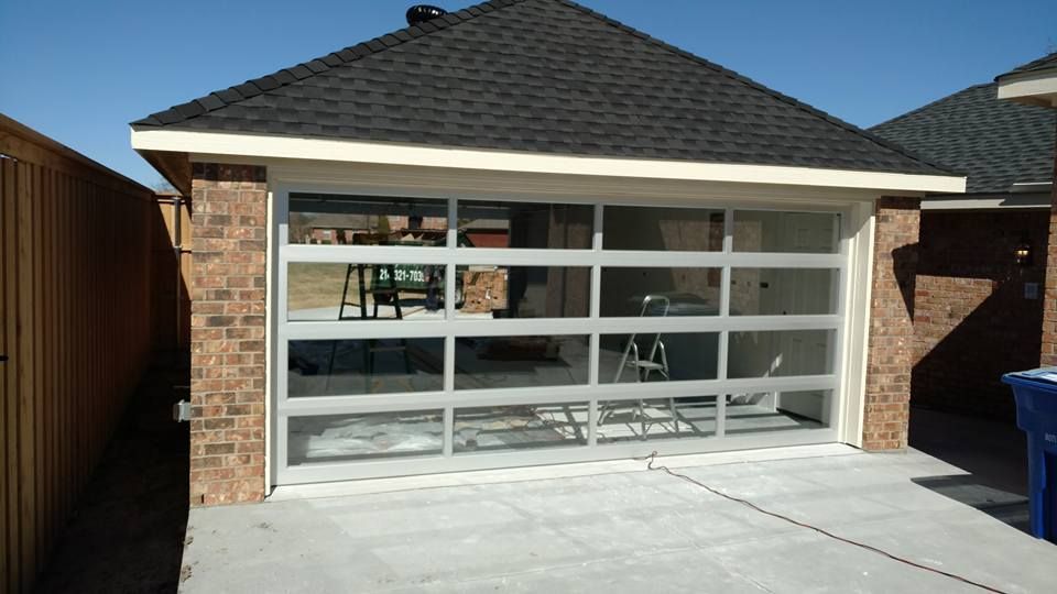 A brick house with a large glass garage door