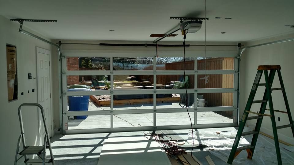 A garage door is being installed in a house.