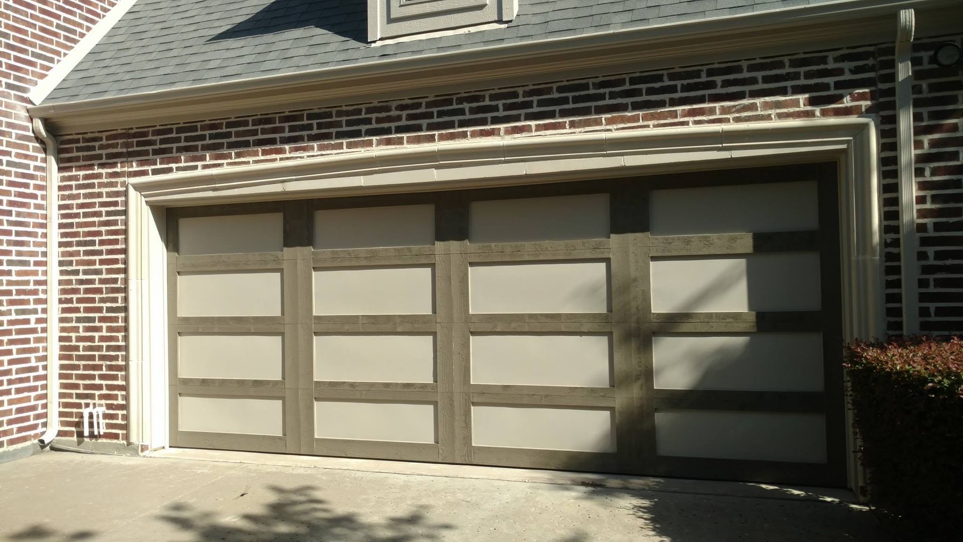 A brick house with a large garage door