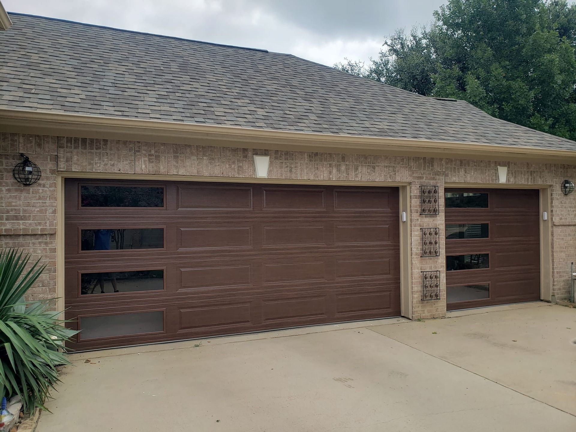 A house with two garage doors and a driveway.